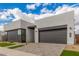 Modern home featuring a gray color scheme, well-kept landscaping, and a minimalist, contemporary design at 10302 E Utah Ave, Mesa, AZ 85212