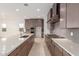 A kitchen island features a sink and stainless appliances with gray cabinets at 10302 E Utah Ave, Mesa, AZ 85212