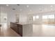 A kitchen island separates the kitchen from the living room in an open floorplan at 10302 E Utah Ave, Mesa, AZ 85212