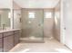 Clean, modern shower and vanity with beige tile in a spacious bathroom with large shower windows at 10302 E Utah Ave, Mesa, AZ 85212