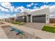 Street showcasing contemporary homes with stylish exteriors, gray tones, and low-maintenance xeriscaped landscaping at 10302 E Utah Ave, Mesa, AZ 85212