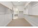 Spacious walk-in closet with white shelving and a neutral carpet, with views of the bathroom at 10302 E Utah Ave, Mesa, AZ 85212