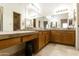 Primary bathroom with dual sinks, tile counters, large mirror, and tile flooring at 10812 N 117Th Pl, Scottsdale, AZ 85259