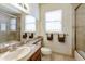 Bathroom with a single sink vanity, large mirror and neutral color scheme and light colored tile at 10812 N 117Th Pl, Scottsdale, AZ 85259