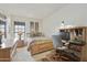 Cozy carpeted bedroom with neutral decor, and a wood desk with chair at 10812 N 117Th Pl, Scottsdale, AZ 85259