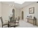 Bright formal dining room with a glass table with seating for four and decorated with arched doorways at 10812 N 117Th Pl, Scottsdale, AZ 85259