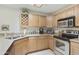 Well-equipped kitchen featuring stainless steel appliances and light wood cabinetry at 10812 N 117Th Pl, Scottsdale, AZ 85259