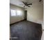 Bedroom with neutral walls, carpeted floor, and a ceiling fan, creating a calming atmosphere at 11521 W Charter Oak Rd, El Mirage, AZ 85335