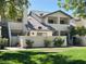 Inviting condo featuring a well-maintained lawn, tiled roof, and modern architectural details at 1222 W Baseline Rd # 159, Tempe, AZ 85283