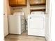 Bright laundry area featuring a white washer and dryer with wood cabinets above at 1222 W Baseline Rd # 159, Tempe, AZ 85283