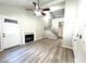 Bright living room with wood flooring, modern fireplace, and an open staircase leading to the loft at 1222 W Baseline Rd # 159, Tempe, AZ 85283