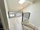 The loft area showcases modern railings, a ceiling fan, and natural light from the skylight at 1222 W Baseline Rd # 159, Tempe, AZ 85283