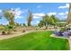 Backyard with a lush green lawn, patio seating, and lovely views of the community golf course at 12534 W Ashwood Dr, Sun City West, AZ 85375