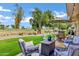 Relaxing back patio with comfortable seating, a fire pit table, and golf course views at 12534 W Ashwood Dr, Sun City West, AZ 85375