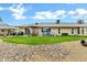 Expansive backyard featuring well-maintained lawn, inviting patio furniture, and ample seating for outdoor relaxation and entertainment at 12534 W Ashwood Dr, Sun City West, AZ 85375