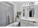 Clean bathroom featuring glass enclosed shower and neutral fixtures, with ample counter space and a modern sink at 12534 W Ashwood Dr, Sun City West, AZ 85375