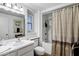 Cozy bathroom with a shower-tub combo, light walls, and a sink with ample counter space, offering a clean and functional design at 12534 W Ashwood Dr, Sun City West, AZ 85375