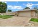 Charming single-story home with a two-car garage, manicured lawn, and patterned concrete driveway at 12534 W Ashwood Dr, Sun City West, AZ 85375