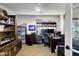 Home office featuring built-in shelving, a work desk, and a comfortable chair, offering a perfect space for productivity at 12534 W Ashwood Dr, Sun City West, AZ 85375