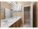 Bathroom featuring a double vanity, decorative mirrors, and a separate toilet and shower at 12706 E Desert Cove Ave, Scottsdale, AZ 85259