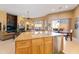 Gourmet kitchen view showcasing the living room, fireplace, and outdoor views at 12706 E Desert Cove Ave, Scottsdale, AZ 85259