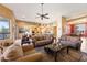 Open-concept living room with a ceiling fan, leading to the kitchen and dining areas at 12706 E Desert Cove Ave, Scottsdale, AZ 85259