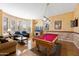 Charming living room with pool table and lots of natural light from large windows at 12706 E Desert Cove Ave, Scottsdale, AZ 85259