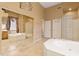 Bright main bathroom with a soaking tub, mirrored walk-in shower, and double vanity sinks at 12706 E Desert Cove Ave, Scottsdale, AZ 85259