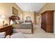 Relaxing main bedroom featuring a ceiling fan, dresser, and cozy decor at 12706 E Desert Cove Ave, Scottsdale, AZ 85259