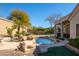 Inviting swimming pool with rock accents and lush landscaping in backyard at 12706 E Desert Cove Ave, Scottsdale, AZ 85259