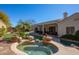 Stunning backyard pool and spa surrounded by rock features and lush landscaping at 12706 E Desert Cove Ave, Scottsdale, AZ 85259