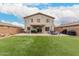 Expansive backyard featuring artificial grass, brick-paved patio, and an open patio and multiple seating areas at 13153 W Clarendon Ave, Litchfield Park, AZ 85340