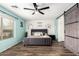 Comfortable bedroom with wood floors, accent wall, and a sliding barn door feature at 13153 W Clarendon Ave, Litchfield Park, AZ 85340