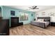 Bedroom with wood flooring, a ceiling fan, and stylish decor at 13153 W Clarendon Ave, Litchfield Park, AZ 85340