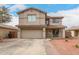 Two-story home featuring a two-car garage, desert landscaping, a covered porch and a 'Welcome' sign at 13153 W Clarendon Ave, Litchfield Park, AZ 85340