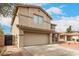 Two-story home featuring a two-car garage, desert landscaping and covered porch area at 13153 W Clarendon Ave, Litchfield Park, AZ 85340