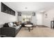 Cozy living room with neutral carpet, gray sofas, and decorative wall art at 13153 W Clarendon Ave, Litchfield Park, AZ 85340