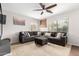 Bright living room features a large gray sectional and natural light at 13153 W Clarendon Ave, Litchfield Park, AZ 85340