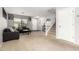 Bright living room with comfortable gray couches and a staircase at 13153 W Clarendon Ave, Litchfield Park, AZ 85340