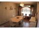 Traditional dining room with chandelier, table, and large wooden cabinet at 13612 W Desert Moon Way, Peoria, AZ 85383