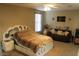 Cozy bedroom with a unique bed frame, ceiling fan, and natural light at 13612 W Desert Moon Way, Peoria, AZ 85383