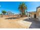 Spacious backyard featuring a tall palm tree, block wall, and covered patio at 13807 N 33Rd Dr, Phoenix, AZ 85053