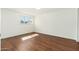 Empty bedroom featuring hardwood floors and a large window for natural light at 13807 N 33Rd Dr, Phoenix, AZ 85053