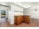 A dining area featuring wooden cabinets, granite countertops, and floating shelves at 13807 N 33Rd Dr, Phoenix, AZ 85053