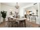 Bright dining room area featuring a decorative chandelier and views to the kitchen at 13807 N 33Rd Dr, Phoenix, AZ 85053