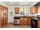 Bright kitchen with wooden cabinets, granite countertops, and stainless steel dishwasher at 13807 N 33Rd Dr, Phoenix, AZ 85053