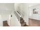 Stairway with carpeted steps, white banister, and a bright entry way at 13807 N 33Rd Dr, Phoenix, AZ 85053