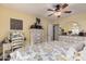 Comfortable bedroom with a ceiling fan, neutral colors, and a classic dresser and vanity set at 14300 W Bell Rd # 117, Surprise, AZ 85374