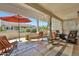 Inviting covered patio with comfortable seating and an umbrella for shade at 15501 W Las Verdes Way, Surprise, AZ 85374