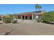 Beautiful backyard with a covered patio and landscaped desert surroundings at 15501 W Las Verdes Way, Surprise, AZ 85374